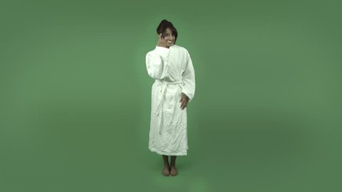 indian woman in bathrobe isolated on green with fingers crossed