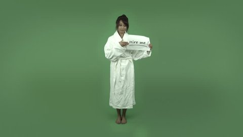 indian woman in bathrobe isolated on green with hire me sign