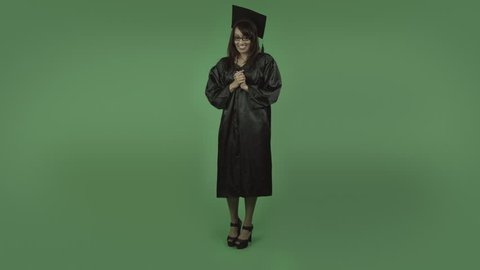 adult student graduate isolated on green with fingers crossed