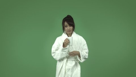 indian woman in bathrobe isolated on green stressed depressed with coffee