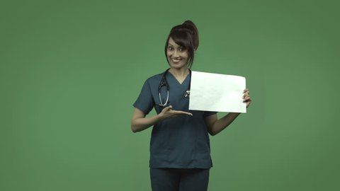 indian female doctor isolated on greenscreen happy with blank sign