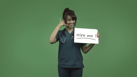 indian female doctor isolated on greenscreen with hire me sign