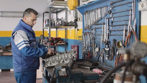 auto mechanic repairing an engine of an automobile