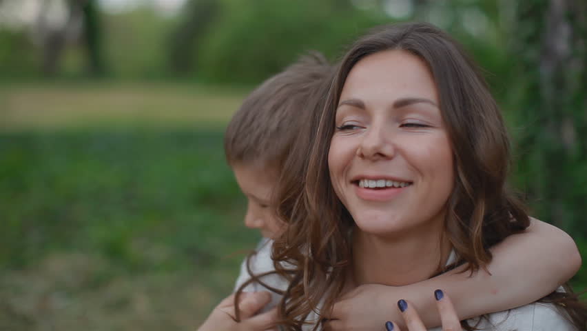 Young attractive mother and son looking into the camera . They are very happy and cheerful
 Royalty-Free Stock Footage #6233591