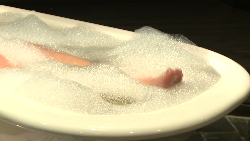 Feet enjoying a relaxing bubble bath