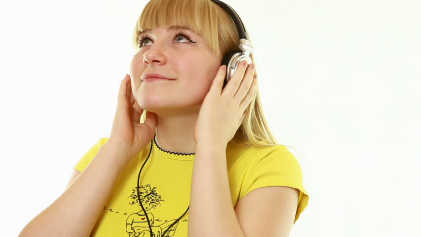 close-up. Young lady listens to music on a white background. The yellow shirt2