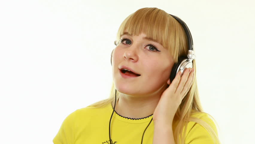 Clouse-up. Young lady listens to music. The yellow shirt-
