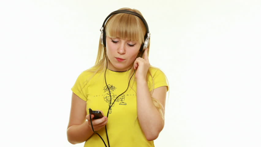Young lady listens to music on a white background. The yellow shirt-1