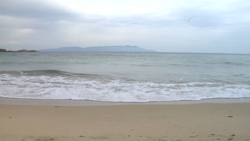 Mediterranean beach with breaking wave (slow motion)
