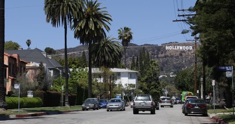 LOS ANGELES, USA - APRIL 3, 2013 Street View Entertainment Symbol Holywood Sign Los Angeles Cars Passing Traffic ( Ultra High Definition, Ultra HD, UHD, 4K, 2160P, 4096x2160 )