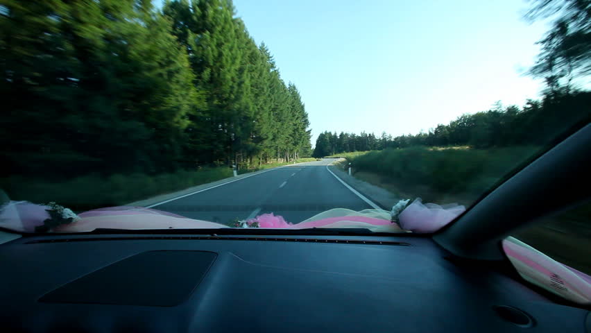 Speeding cars on wedding day through country lanes
