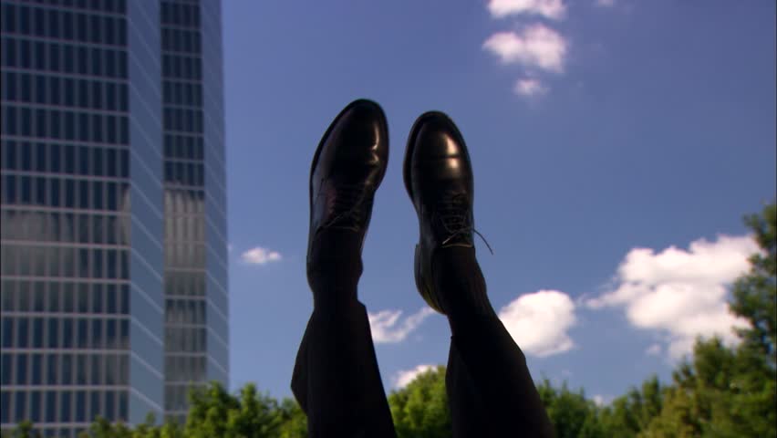 feet dangling in front of office building