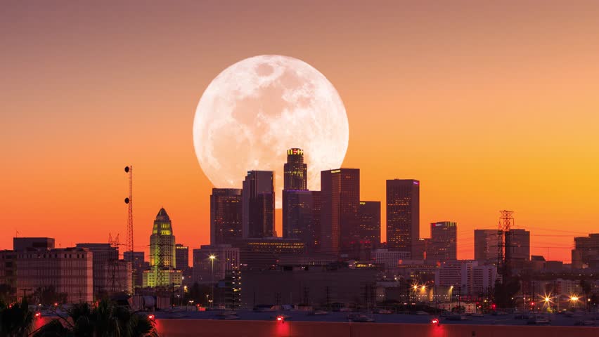 4K UHD. Big full moon rising behind downtown Los Angels city skyline. Timelapse.