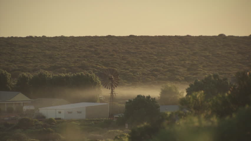Morning fog over a small village and dense vegetation