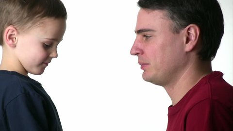 Boy and his dad having a thumb war on a white background