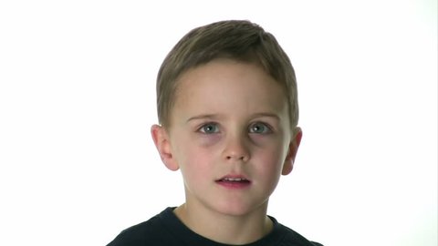 Kid makes a variety of faces in front of a white background