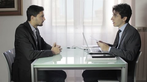 two young businessmen in meeting, two businessmen working on the laptop