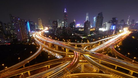 4k video,Timelapse of freeway busy city rush hour heavy traffic jam highway Shanghai at night,the light trails of traffic with super long exposures,Brightly lit urban morden building. gh2_07511_4k