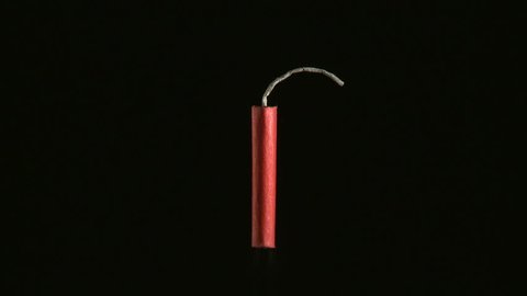 Firecracker being lit with match and exploding 
