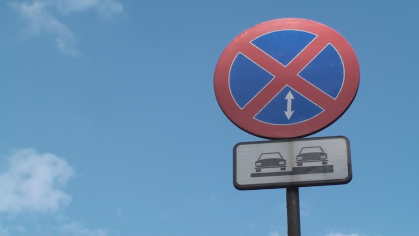 No Parking Allowed Here Street Sign, With A Blue Sky In Background,Low Angle Pan
