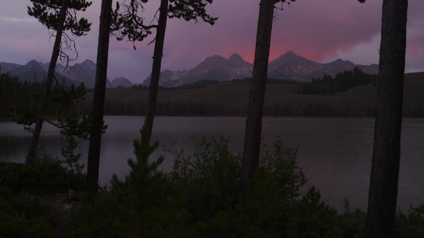 Wide shot scenic view of lake and mountains at sunset / Redfish Lake, Idaho, United States