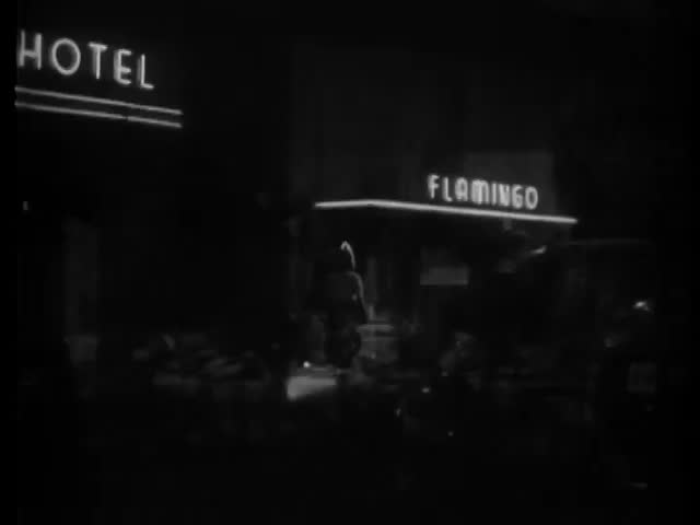 Wide shot or car pulling up in front of nightclub, 1940s