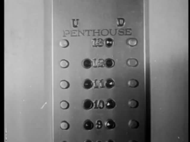 Close-up of man pressing elevator button to penthouse