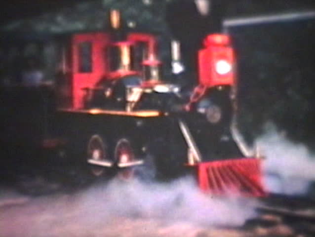 Winnipeg - CIRCA 1964: A miniature train begins another adventure with excited passengers, young and old in Winnipeg, Manitoba, Canada.