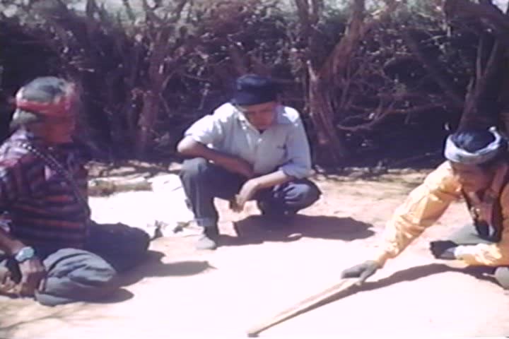 CIRCA 1930s - American Indian tribal leaders make a sand painting in the 1930s.