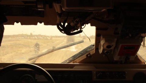 pov from MRAP driver following in convoy in middle east