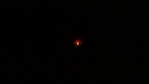 Fire ball flying against a black sky 