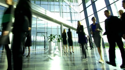 Time lapse of diverse business group in a large modern corporate building