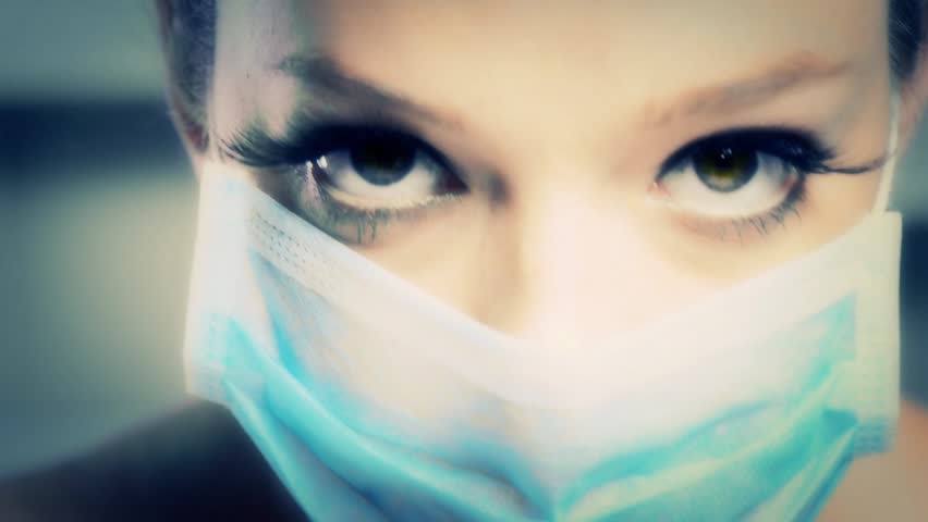 Doctor or nurse woman with blue surgical mask showing her eyes and eyelashes | Shutterstock HD Video #6287978