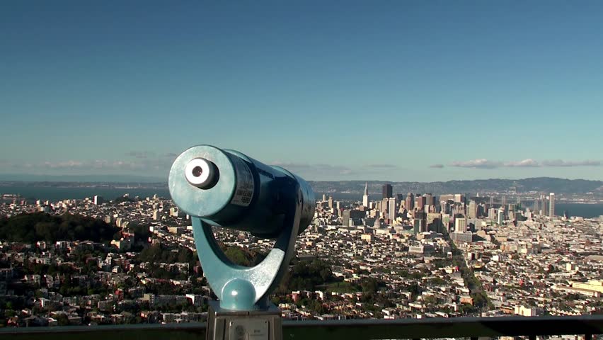 Tourist is looking through a telescopic tower