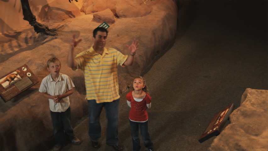 Medium Shot Man with daughter (8-9) and son (10-11) in natural history museum