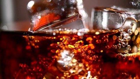 Cola background. Pouring Cola with Ice and bubbles in glass. Food background. Stock full HD video footage 1920x1080p, 1080
