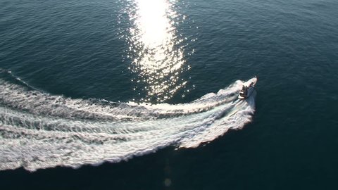 Aerial view of luxury boat navigating in the sea at full speed
