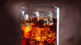 Cola with ice. Pouring Cola with Ice and bubbles in glass. Soda. Food background. Stock full HD video footage 1920x1080p. Slow motion 240 fps