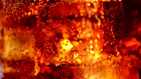 Cola with ice cubes background. Cola with Ice and bubbles in glass. Soda closeup. Food background. Stock full HD video footage 1920x1080p, 1080