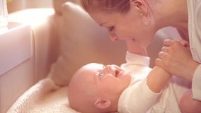 Mother and her Newborn Baby. Happy Mother and Baby kissing and hugging. Resting together. Maternity concept. Parenthood. Motherhood Beautiful Happy Family Footage. Full HD 1920x1080 Slow Motion 240fps