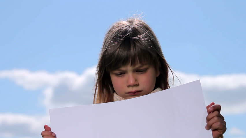 Boy holding a sheet of paper.Child holding a sheet of paper