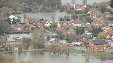 Environmental damage by flooding, Surrey, UK - Aerial view of natural disaster homes and businesses flooded Thames Valley Surrey, Southwest England, UK