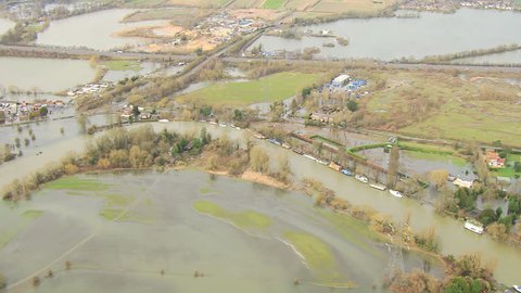 Flooding environmental disaster, Thames Valley, UK - Aerial view of server environments damage by floodwater bust river banks, Thames Valley, Surrey, UK
