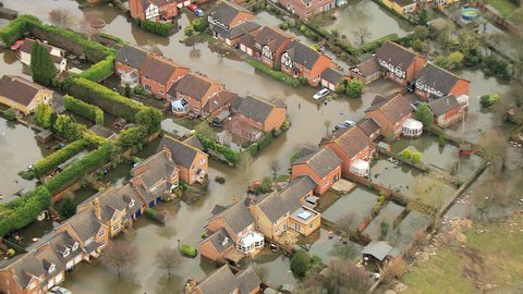 Environmental damage by flooding, Surrey, UK - Aerial close up view environmental damage by floodwater around dwellings from rivers bursting banks, England, UK