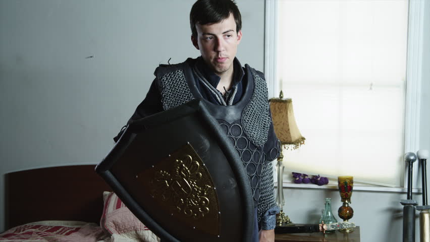 Medium Shot Man wearing armor playing with sword 