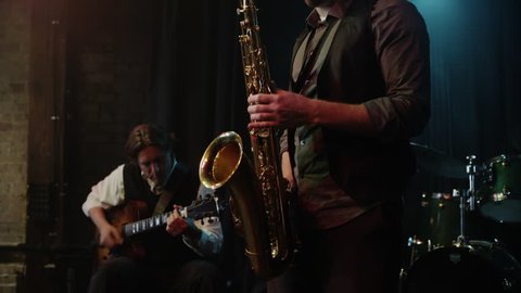 Panning shot of musician playing saxophone  Stock Video