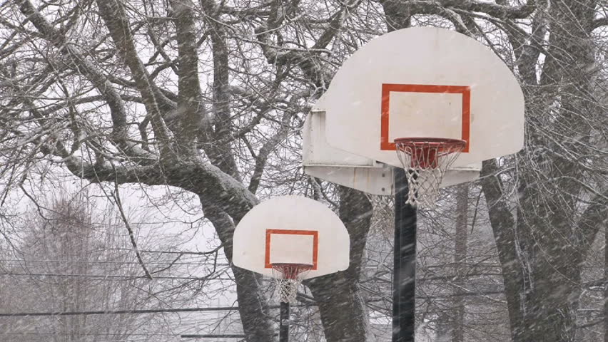 Basketball hoops and snow fall.