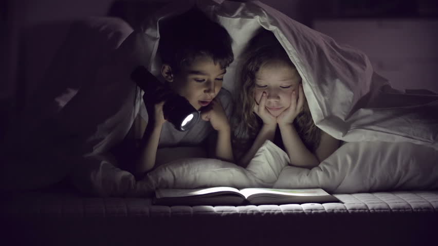 Children with flashlight reading Royalty-Free Stock Footage #6326189