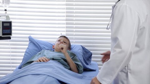 A pediatrician examines one of his hospitalized patients.