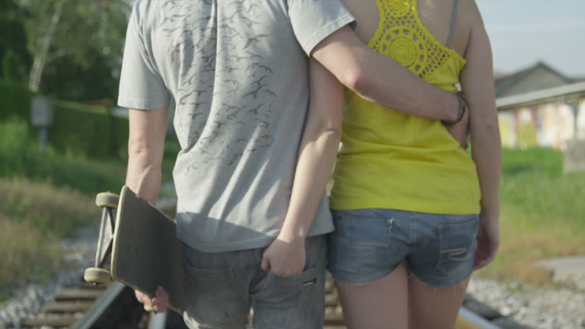 SLOW MOTION: Young couple in love walking on railroad tracks | Shutterstock HD Video #6332591